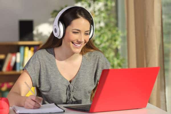 a woman wearing a headset while looking at a computer